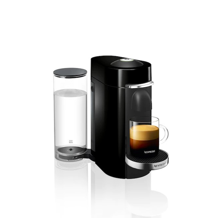 Fresh coffee streaming from Nespresso Vertuo Next Deluxe machine into a ceramic cup